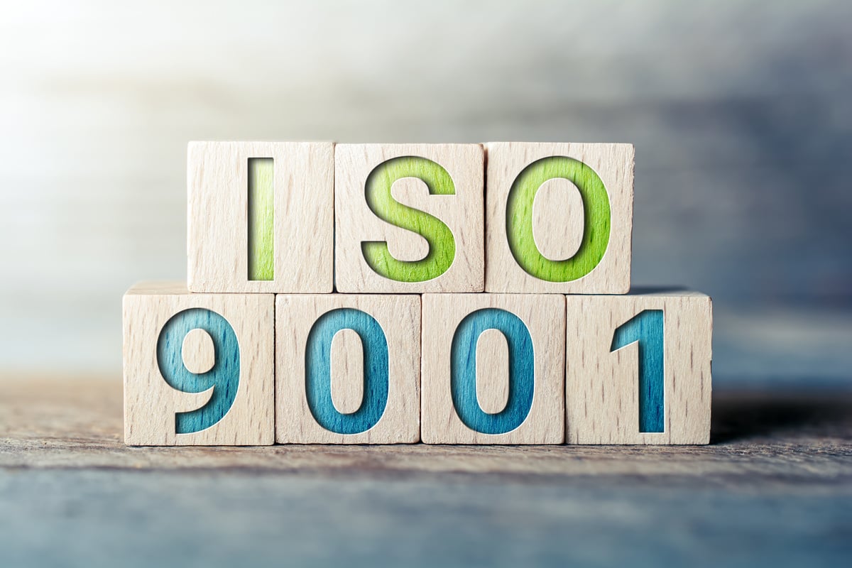 ISO 9001 Written on Wooden Blocks on a Board